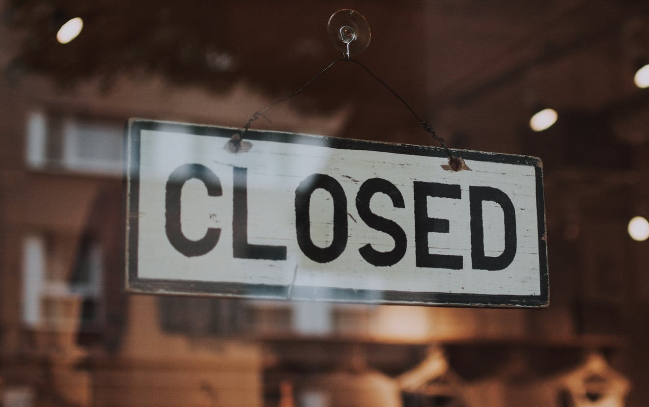 closed sign in business window