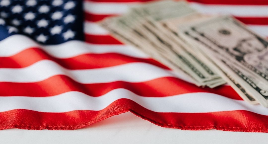 american flag with cash on top