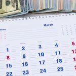 cash with calendar and calculator