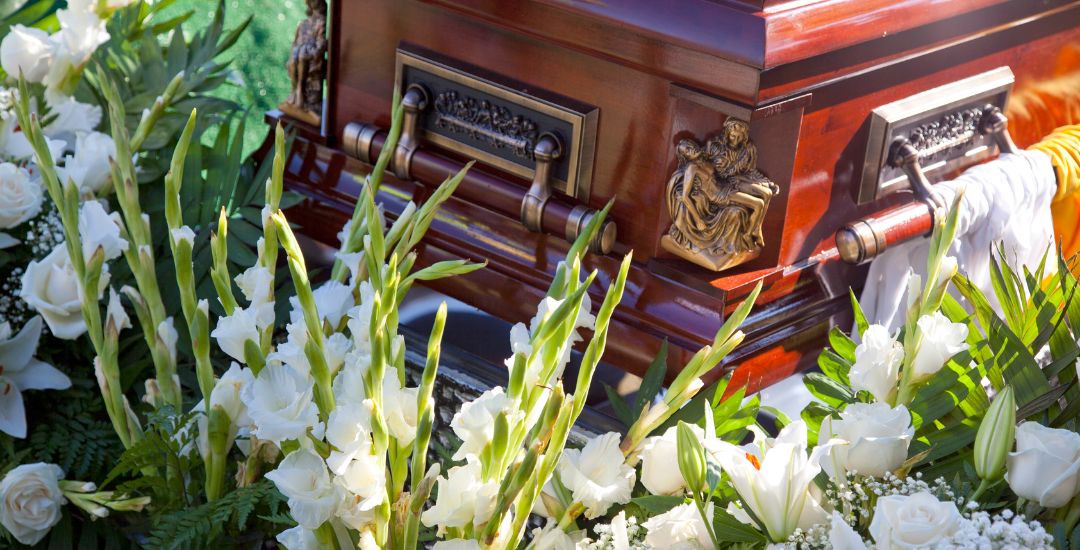 funeral casket with white lilies