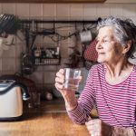 elderly woman sitting in kitchen